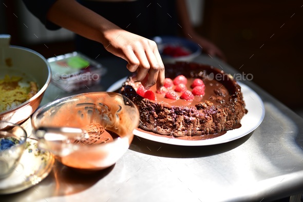 Candid Lifestyle Photo of a Young a Girl decorating a Chocolate Cake ...