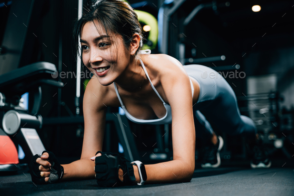 Fit young woman maintaining a plank position on a stability ball to improve core strength