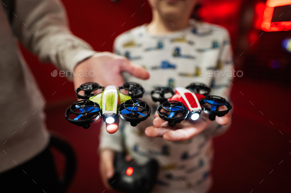 Children flying remote control drones game indoor play zone.