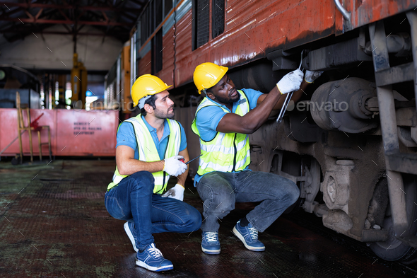 Railroad train maintenance engineer sitting inspection wheel transmission system and walkie talkie