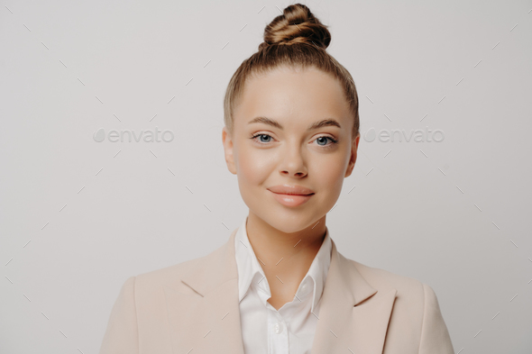 Confident attractive business lady in beige suit - Stock Photo - Images