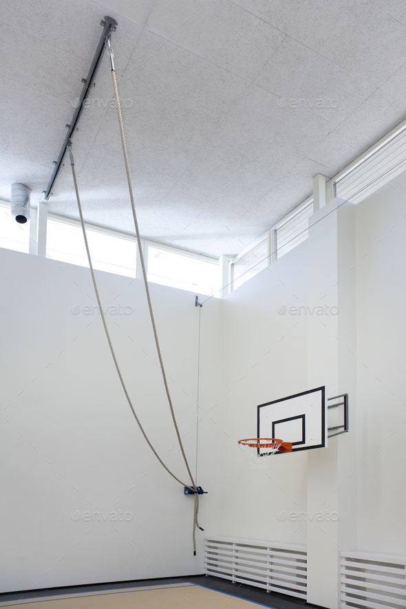 Indoor sports hall in a school, climbing ropes attached to the ceiling