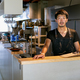 A man standing at the counter of a restaurant kitchen, the owner or manager. - PhotoDune Item for Sale