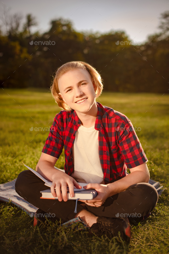 happy student boy study in green park, smiling and looking at camera. get good grades