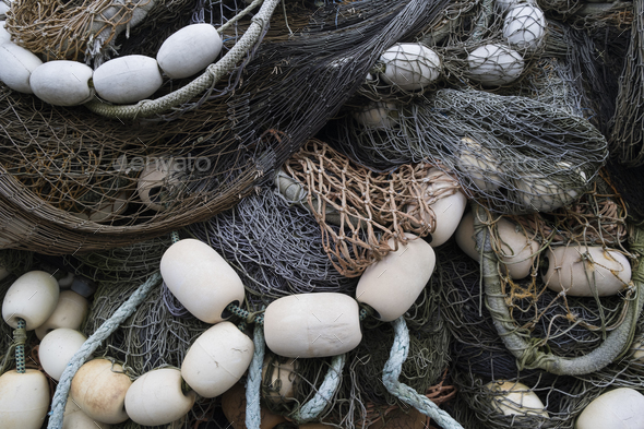 A pile of commercial fishing nets with ropes and floats. Stock