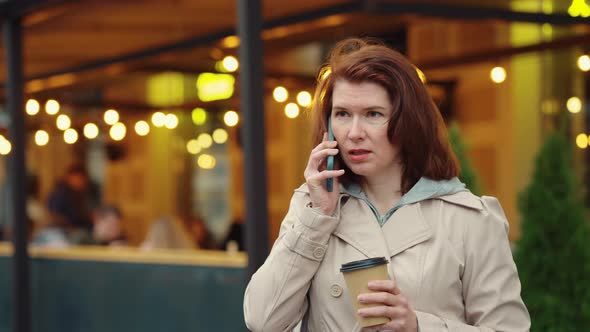 Business Woman Talking on Phone During Coffee Break alt