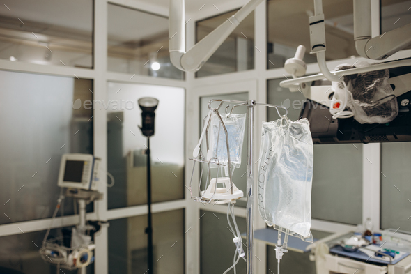 IV infusion bags and bottles hanging on poles during a real surgery ...