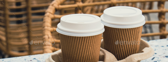 Two paper cups with lid for tea to go. Coffee take away on the table ...