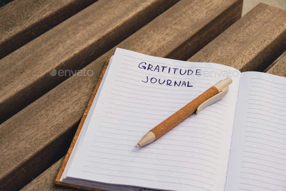 Writing Gratitude Journal on wooden bench. Today I am grateful for. Self discovery journal, self