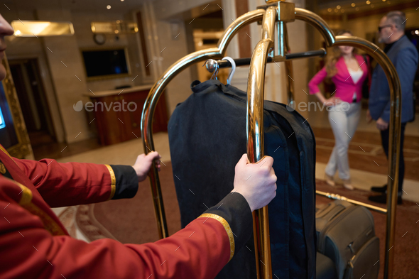 Man and his companion are standing in foyer of luxury hotel