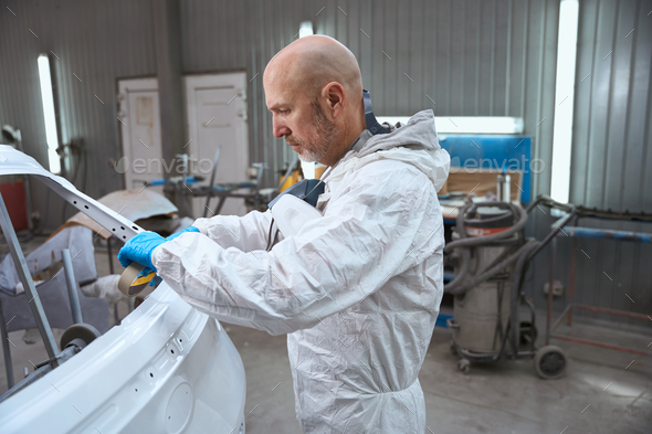 Master paint shop prepares part of car body for work