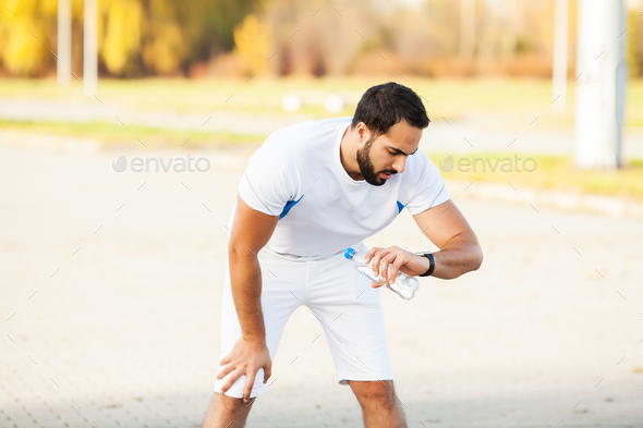 Fitness. Stretch man doing stretching exercise. Standing forward bend stretches of legs