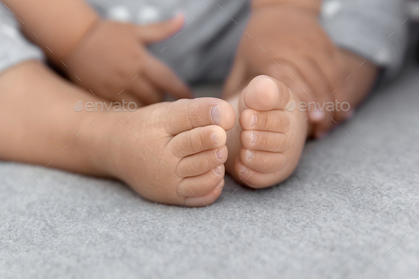 Infant baby feet at natural light, babyhood and childhood concept - Stock Photo - Images