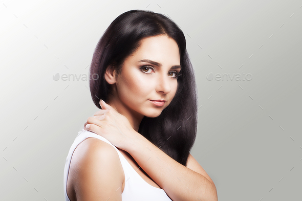Shoulder pain. The woman holds two hands over the neck and shoulders