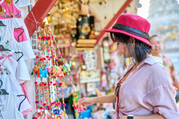 thai woman shopping for souvenirs at wat arun temple in bangkok ...