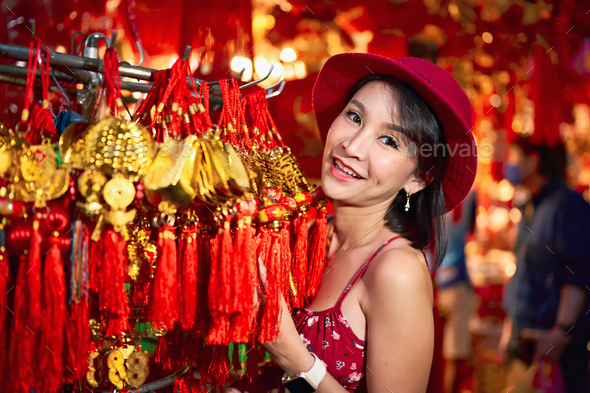 thai woman posing with good luck charms at yaowarat in bangkok thailand during chinese new year