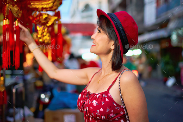 thai woman shopping for good luck charms at yaowarat china town in bangkok thailand