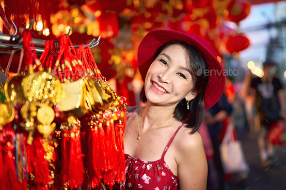 thai woman posing with good luck charms at yaowarat china town in bangkok thailand