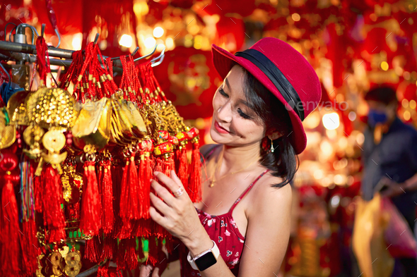 thai woman posing with good luck charms at yaowarat china town in bangkok thailand