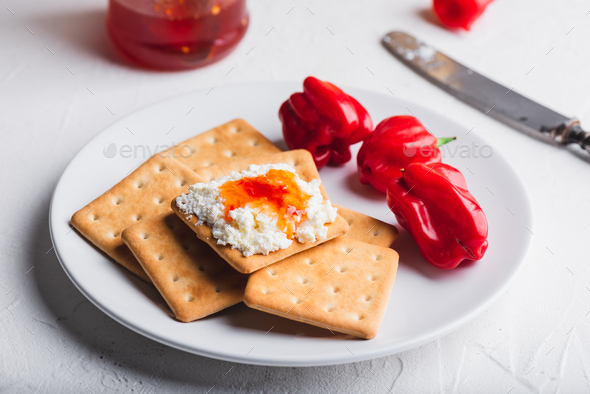 Habanero sauce with cream cheese on crackers - Stock Photo - Images