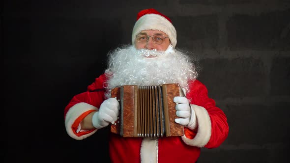 Santa Claus plays the accordion.