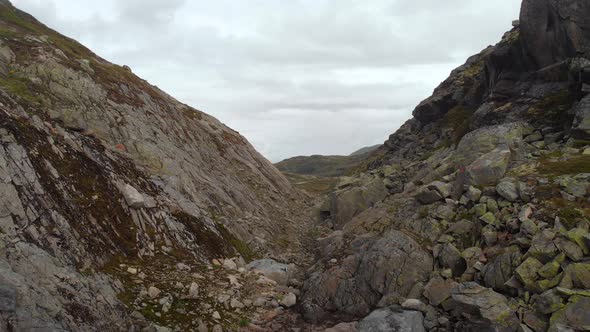 Rocky Norwegian gorge, aerial flight through canyon alt