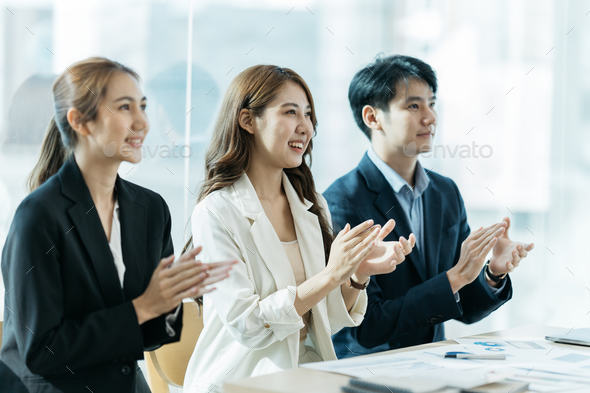 Great job! Successful business team is clapping their hands in modern workstation, celebrating the