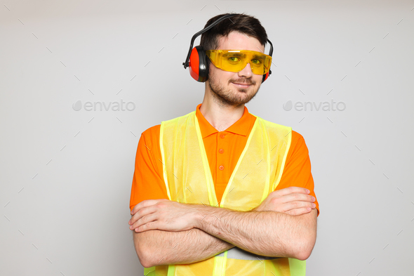 Young man civil engineer in ear protectors