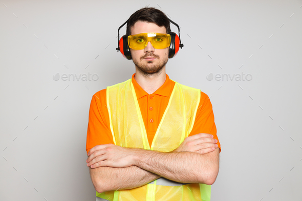 Young man civil engineer in ear protectors