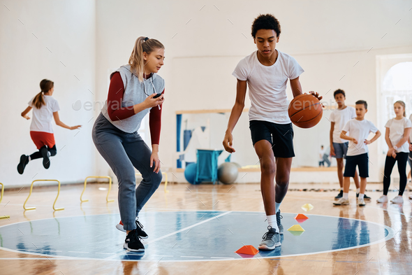 black children playing basketball