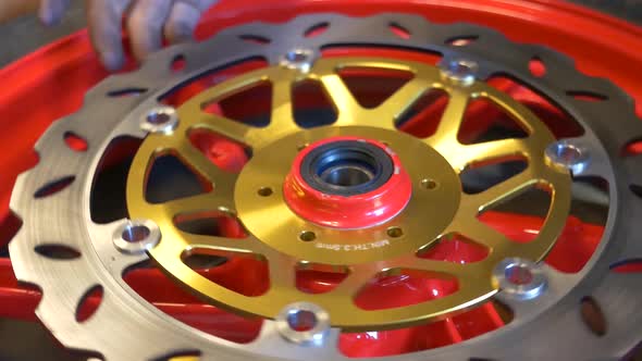 Close-up Footage of Mechanic Working On Disc Brake Installation For Motorcycle alt