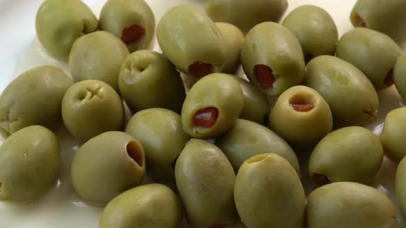 Appetizing green olives stuffed with red pepper