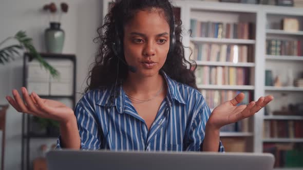 Head Shot Happy Friendly Indian Woman in Headset Holding Video Call Via Laptop alt
