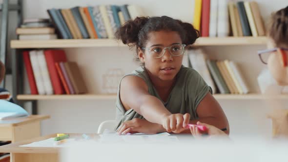 Diverse Schoolgirls Sharing Felt Tip Pens during Lesson alt