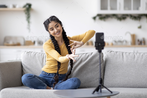 Smiling Indian Woman Recording Video Of Traditional Hand Dance At Home