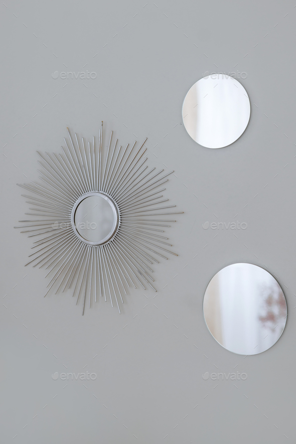 Silver round wall mirrors framed by Sun-Ray.