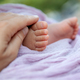 Newborn baby feet and mother&#39;s hand at natural light, motherhood and babyhood concept - PhotoDune Item for Sale