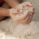 Boy holding sand in hands at the beach in summer time, family vacation concept - PhotoDune Item for Sale