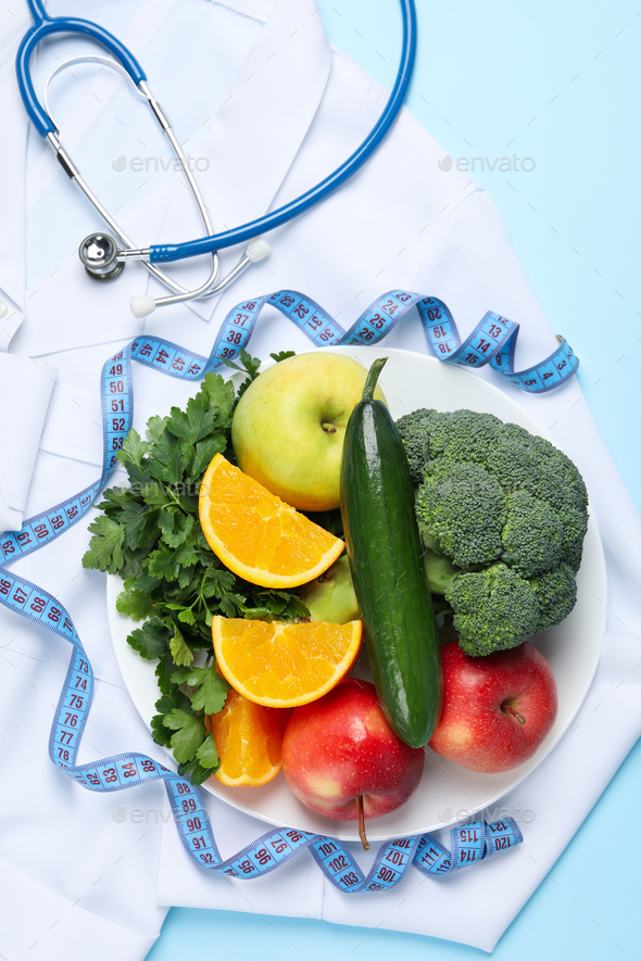 Healthy food and doctors accessories on blue background - weight