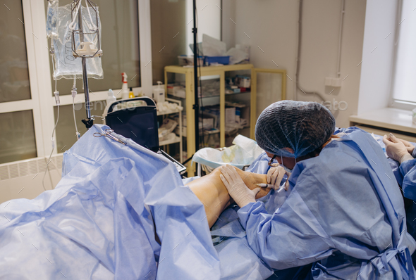 A doctor does medical procedure Sclerotherapy used to eliminate varicose veins and spider veins.