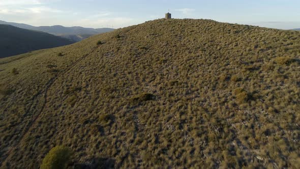 Old Abandoned Lookout Tower with a Spanish Flag alt