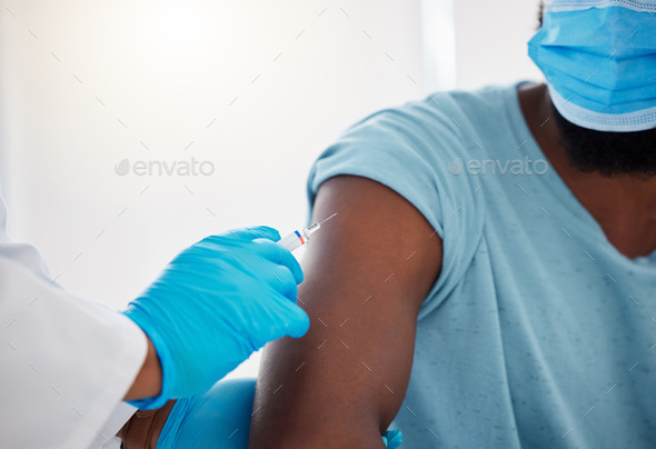 Hand of a doctor holding a needle with the vaccine. The covid vaccine will cure my patients. Africa