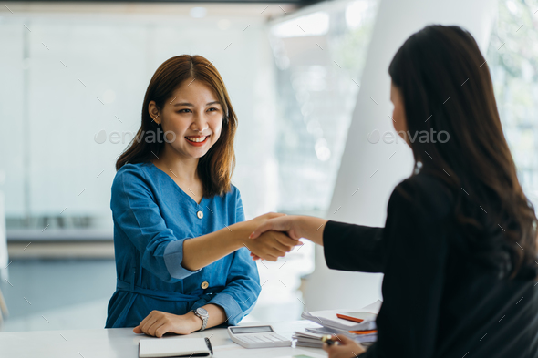 Portrait young Asian woman interviewer and interviewee shaking hands for a job interview .Business - Stock Photo - Images