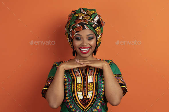 Cute beautiful young black woman posing on orange background Stock ...