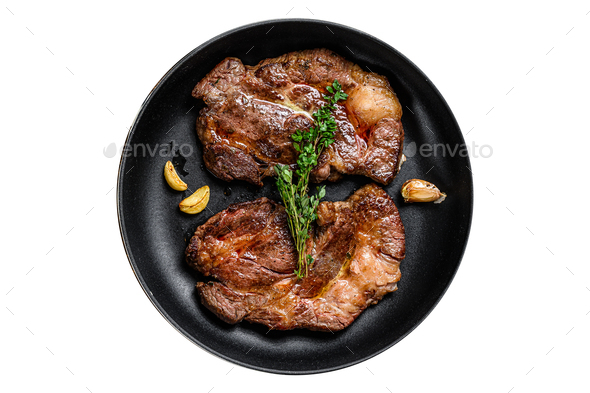 Grilled marble meat steaks Chuck eye roll in a pan. Isolated on white background.
