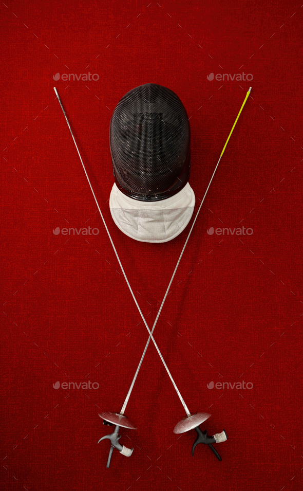 Fencing equipment concept, crossed swords and protective helmet with