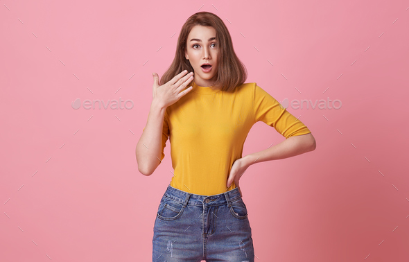 Shocked excited Beautiful woman with mouth open isolated on pink studio ...