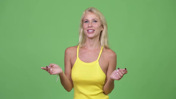Young Happy Beautiful Blonde Woman Presenting Something