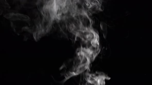 Cloud of Cigarette Smoke on Black Background alt