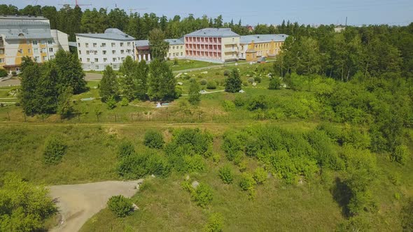 Distant Couple in Park on Green Hill on Nice Day Aerial View alt